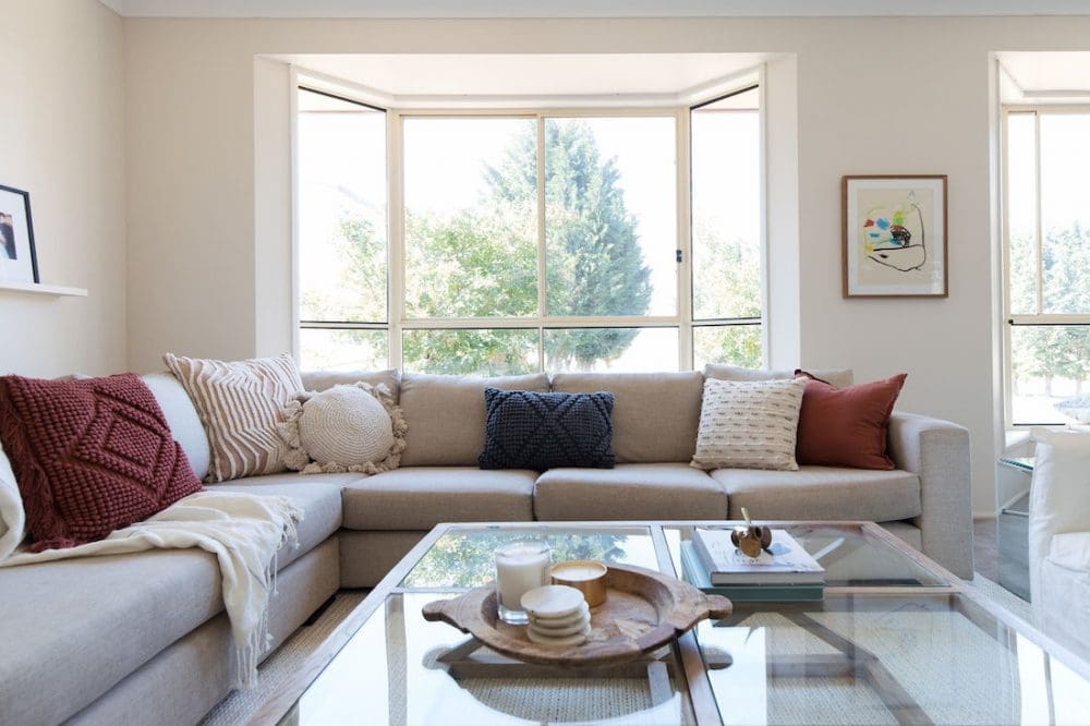 Couch with rust, cream and navy cushions