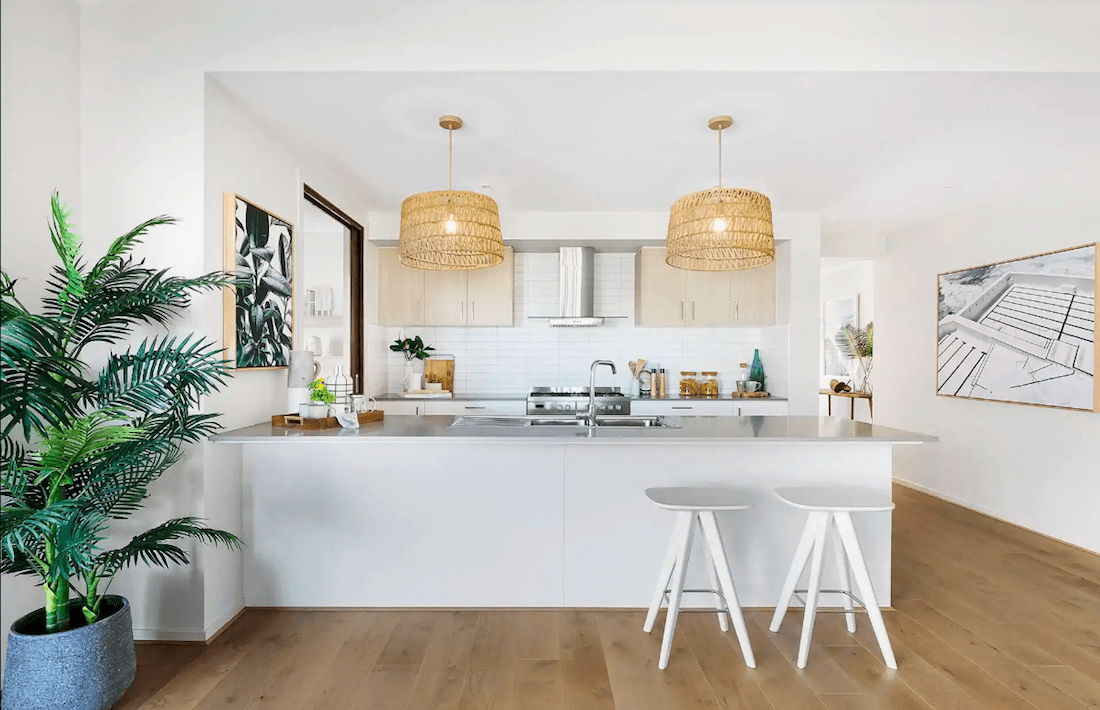 modern coastal kitchen with round rattan pendants and palm tree