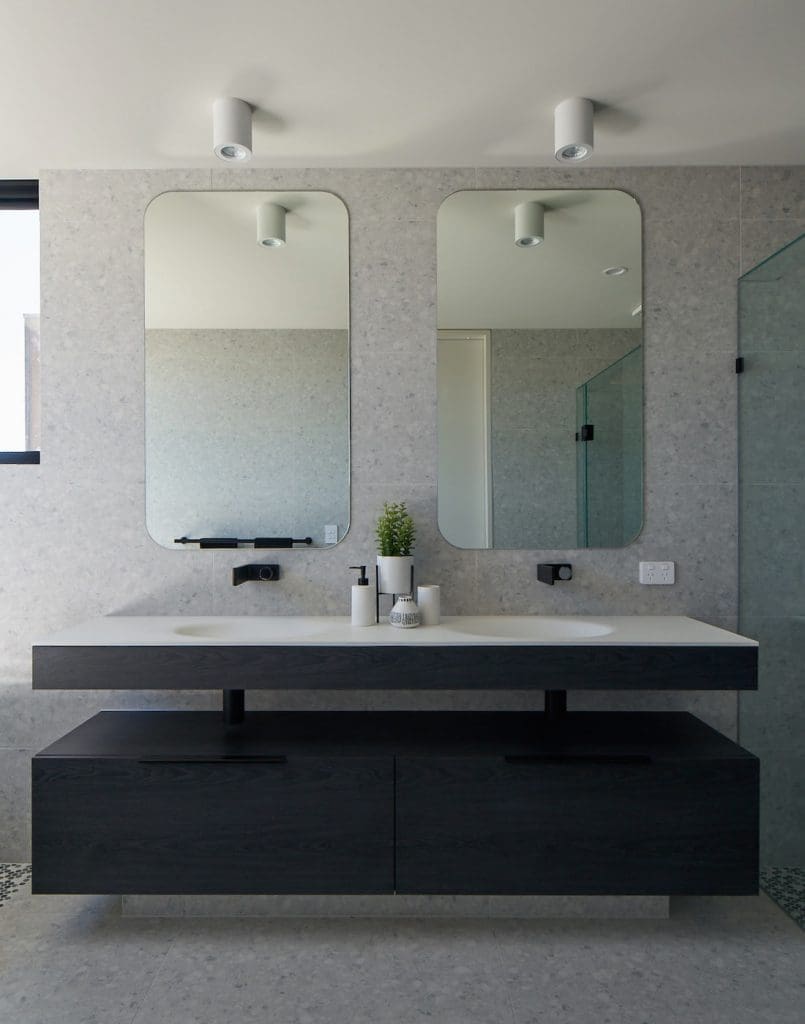 Modern bathroom with rectangular curved mirrors