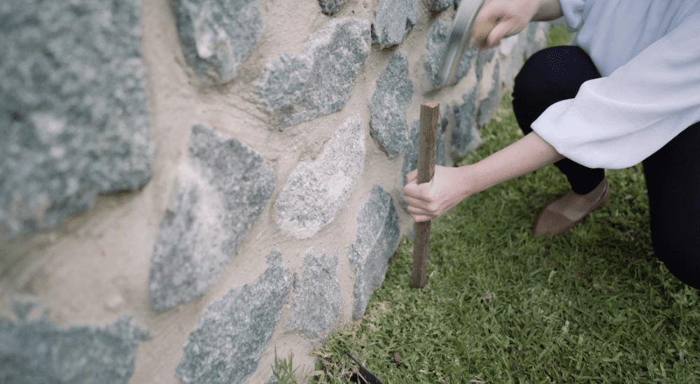 Hammer stakes into ground