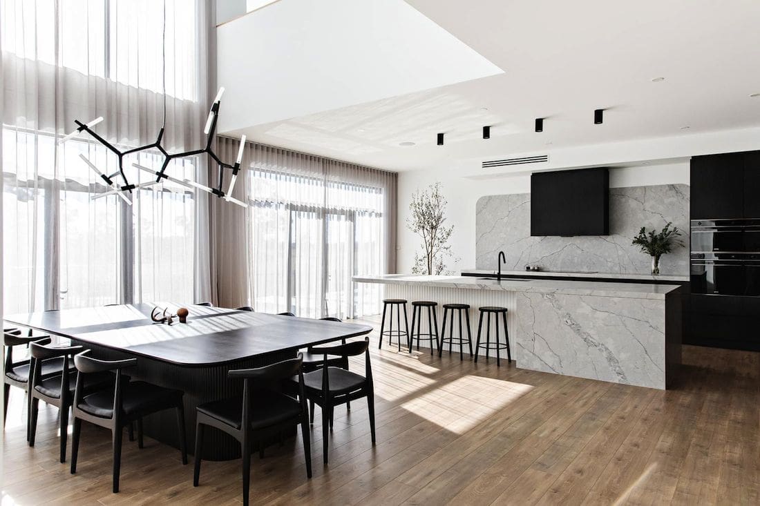 Open plan black kitchen dining space