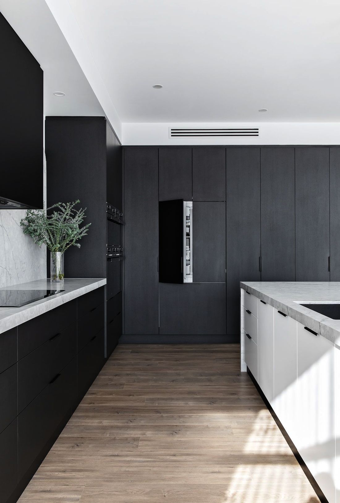 Black kitchen with integrated fridge