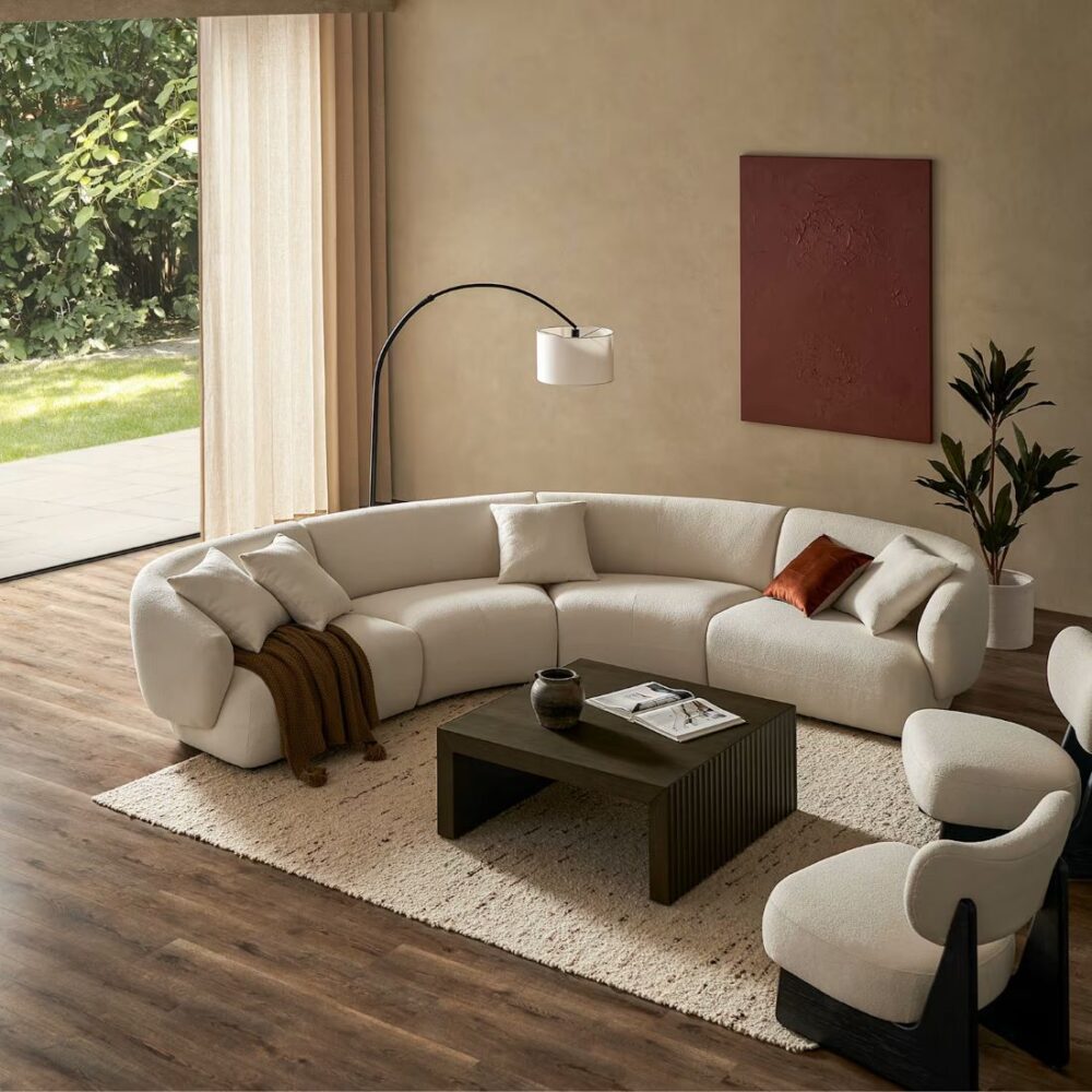 Auburn Performance Bouclé Curve L-Shape Sectional Sofa with Ottoman in Chalk bouclé, featuring a curved modular design, deep cushioned seating and soft rounded edges.