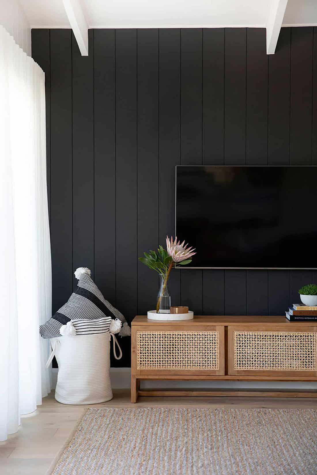 Black wall with panels in living room