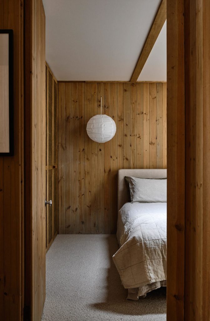 Wood panelled bedroom with paper lantern light