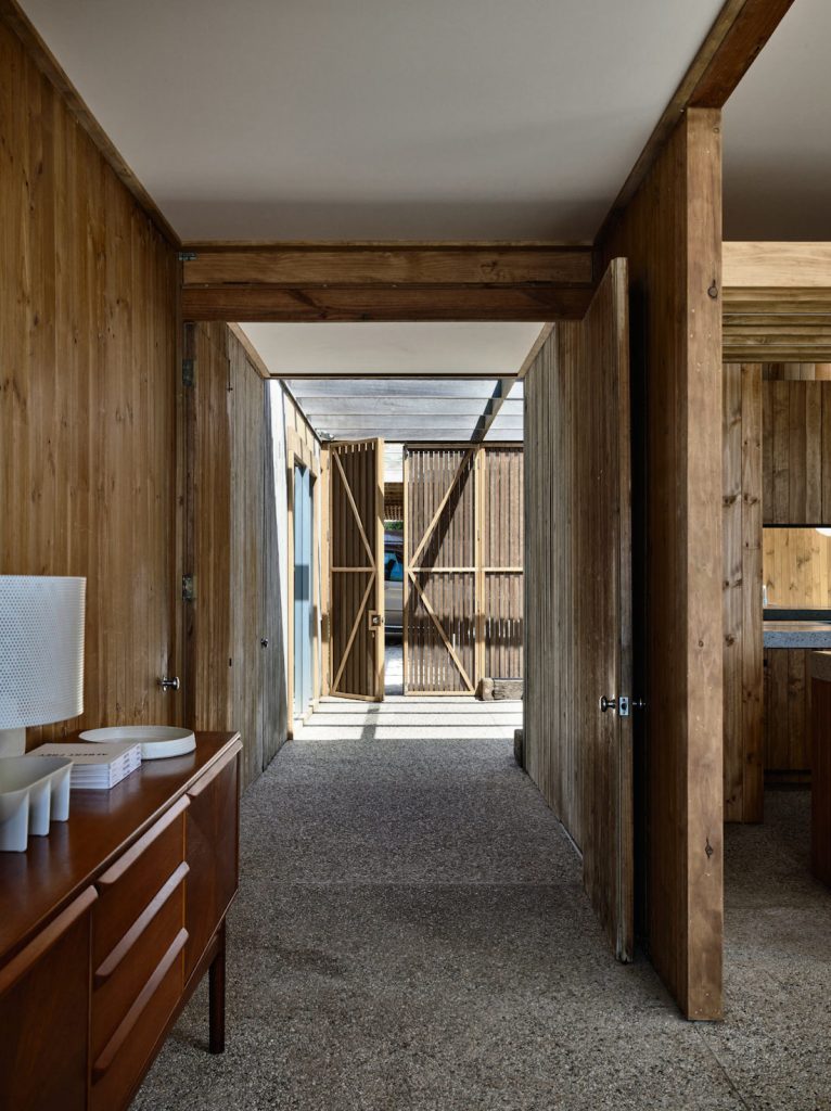 Timber panelled hallway with pebble crete flooring