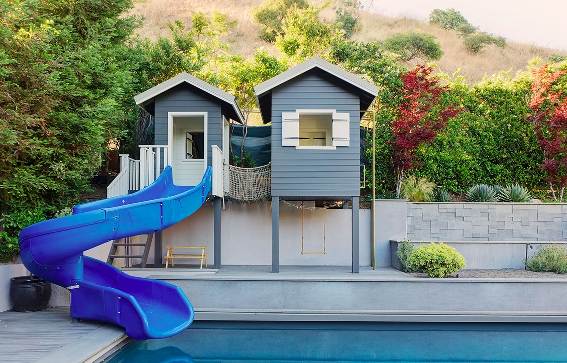 Cubby house with slide into pool