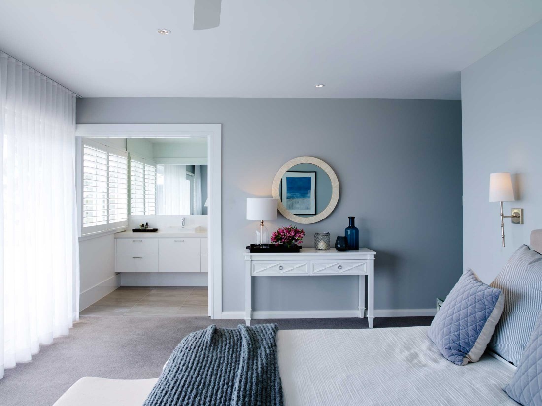 Coastal Hamptons home bedroom with open door ensuite