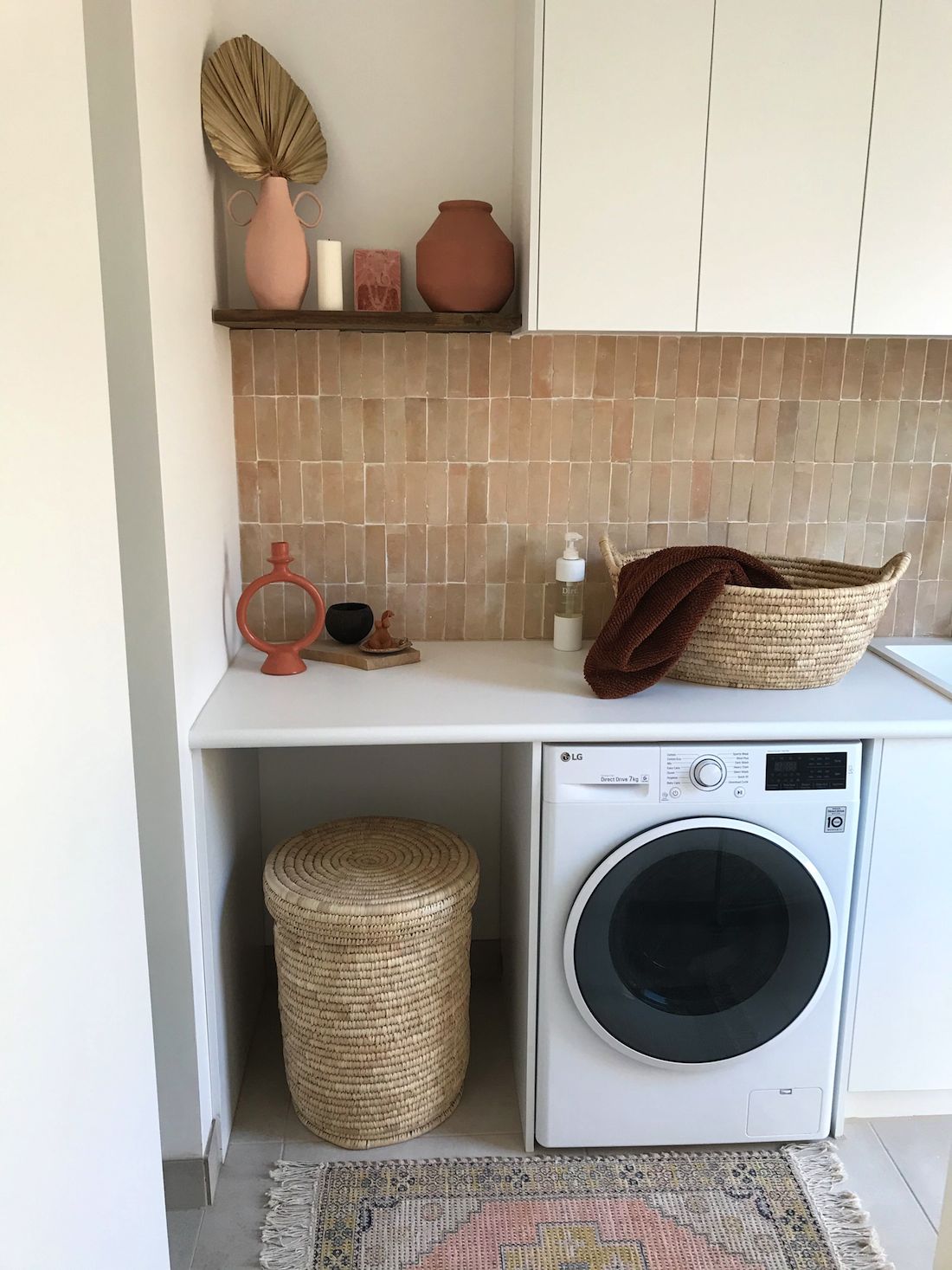 Modern Mediterranean laundry with pink feature tile