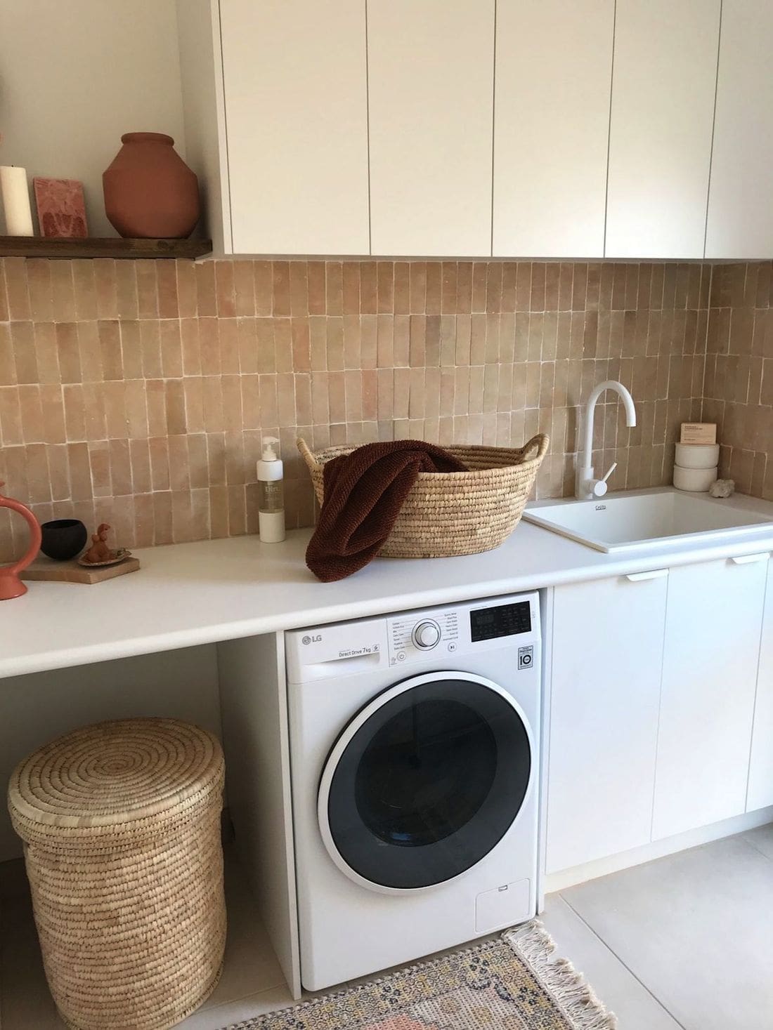 Modern Mediterranean laundry with pink feature tile