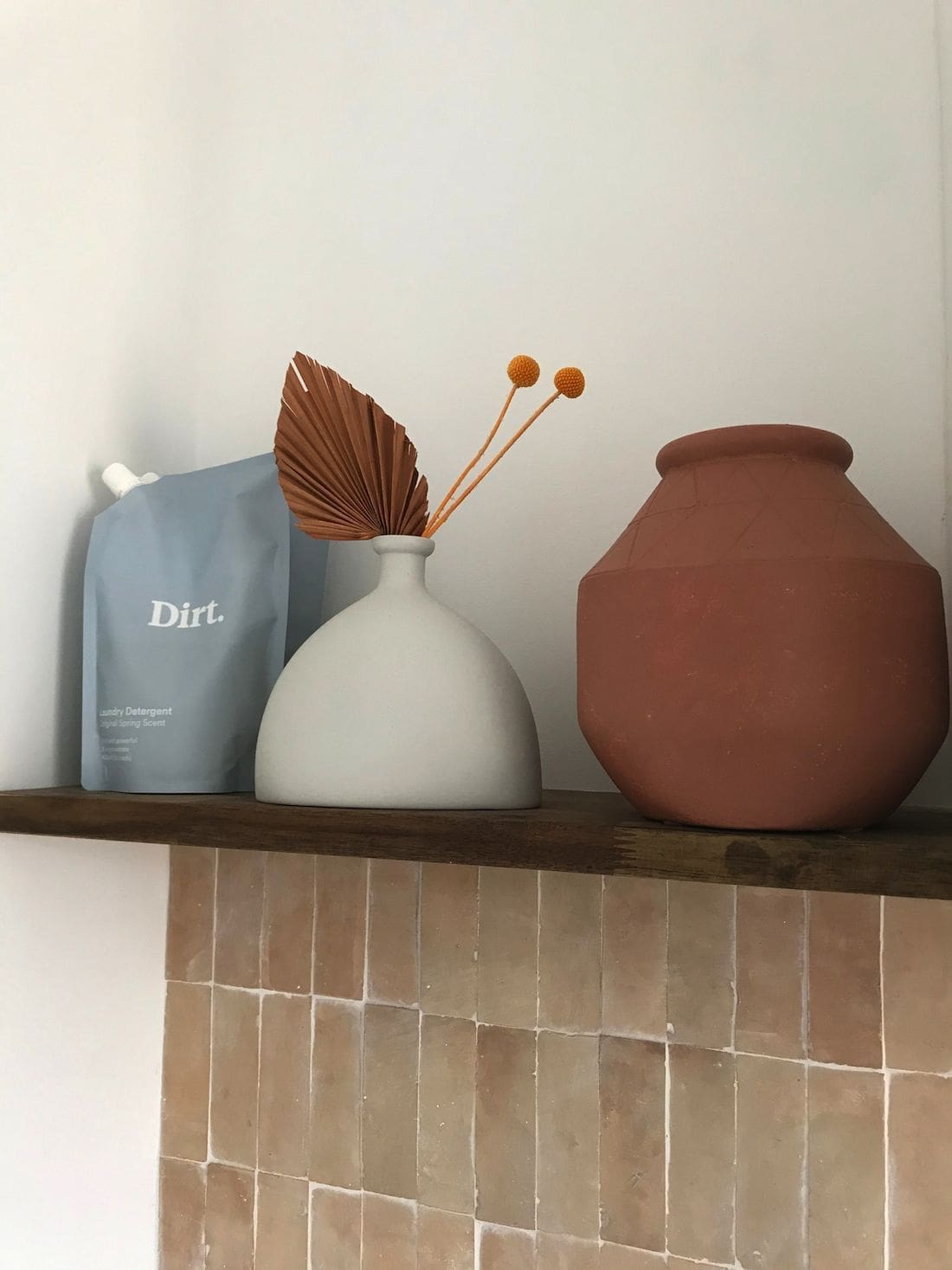 Laundry shelf styling with pink tiles