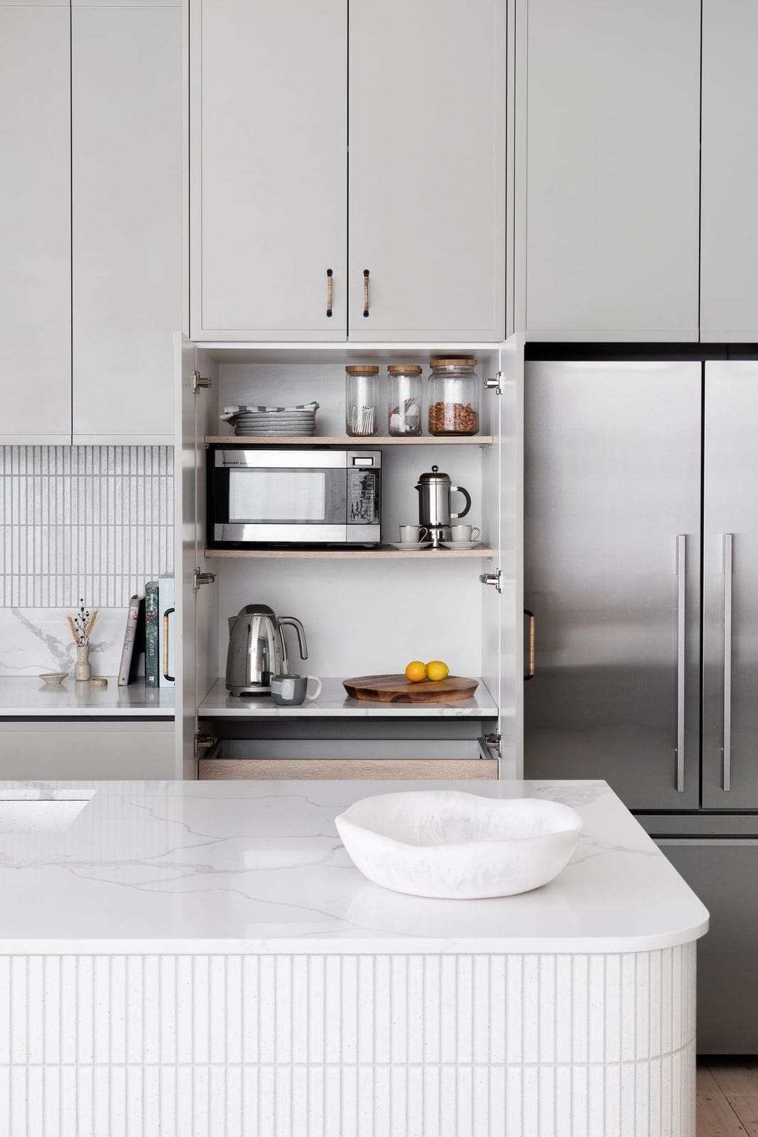 Pocket door in white tiled kitchen