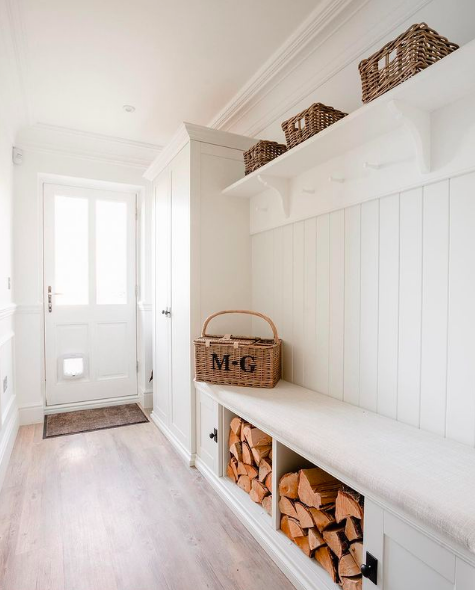 White mudroom with timber cuts and overhead storage baskets