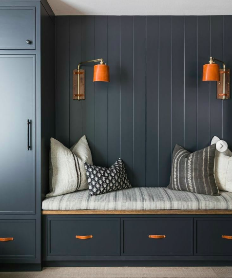 Dark navy panelling with leather accents - mudroom