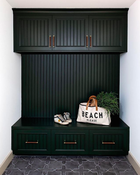 Black panelled mudroom with patterned floor