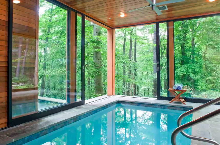 Indoor pool with view of woods