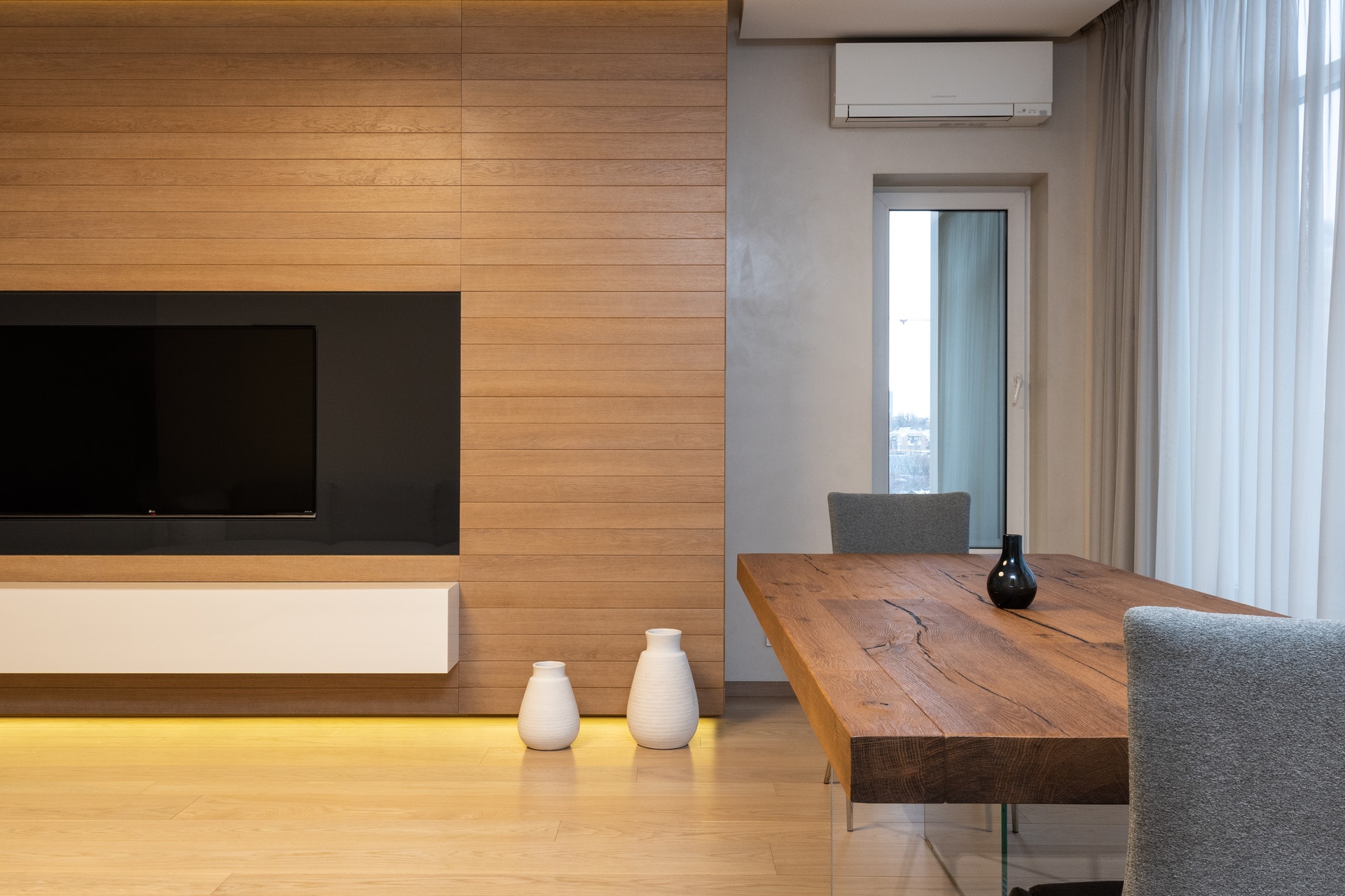 Living room with TV, dining table and reverse cycle air conditioner