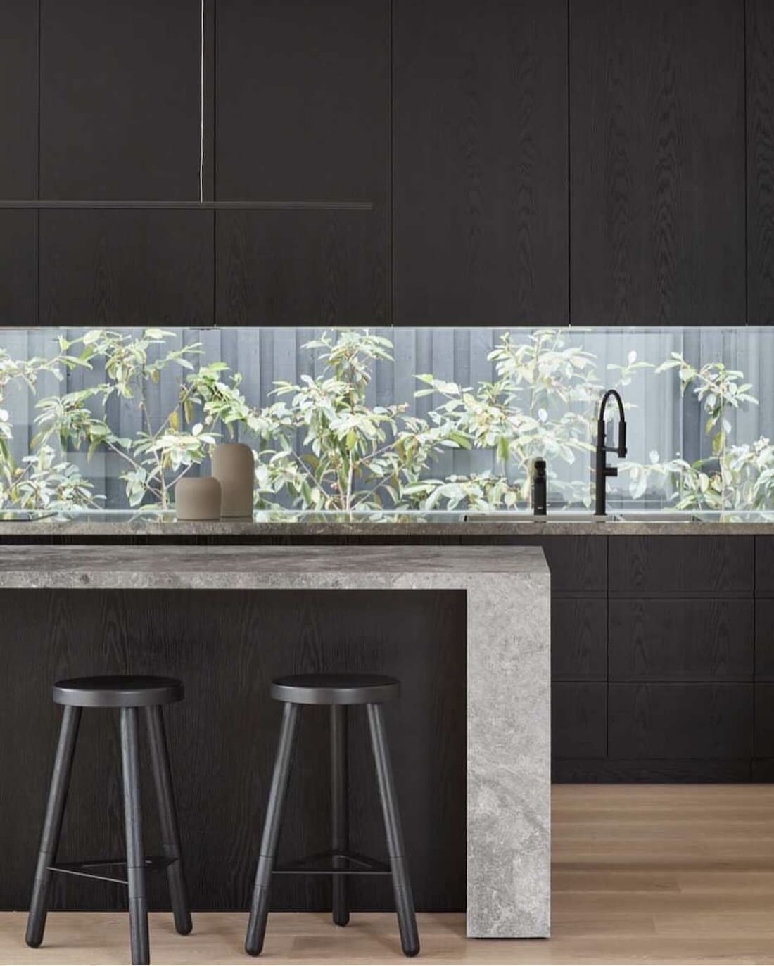 Black kitchen with window splashback