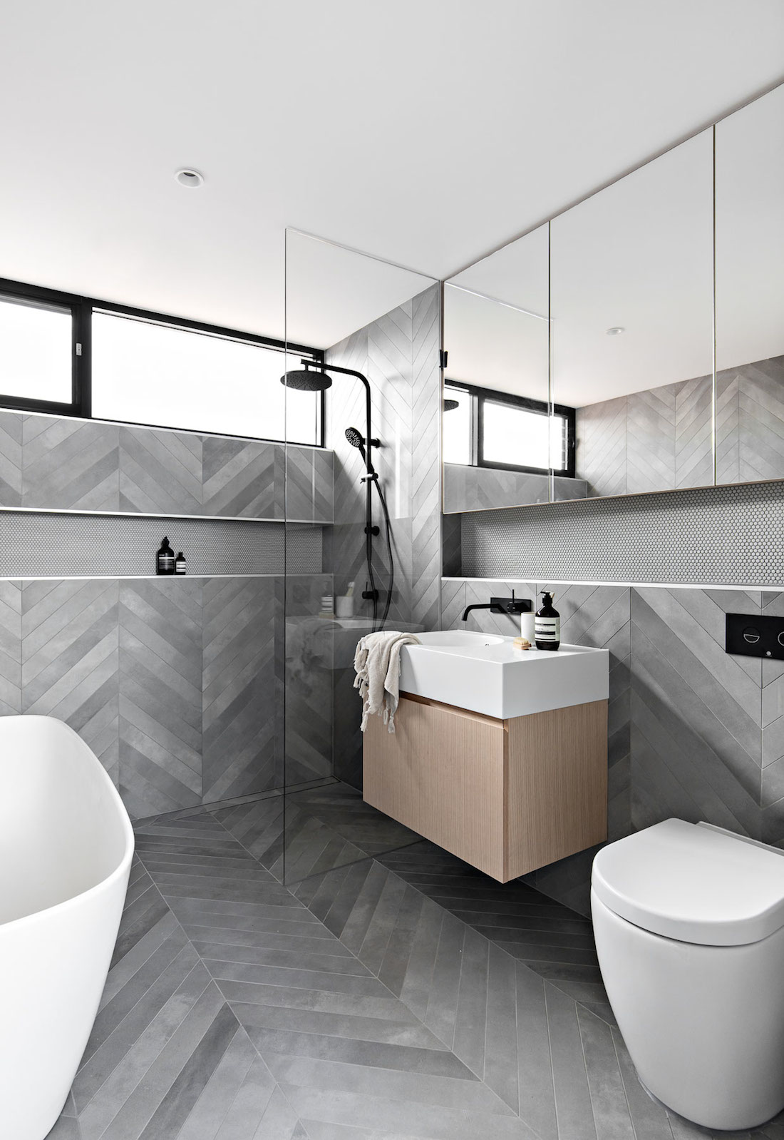 Grey herringbone patterned bathroom