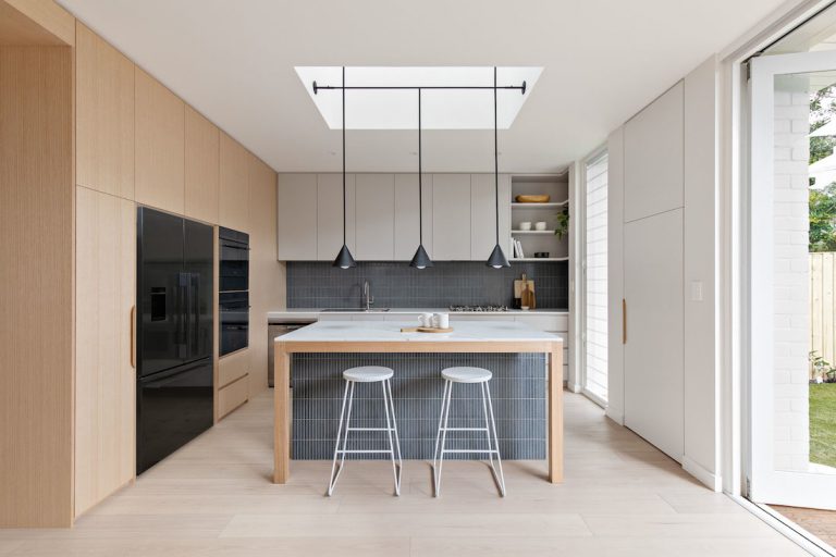 Small kitchen with skylight and grey backsplash
