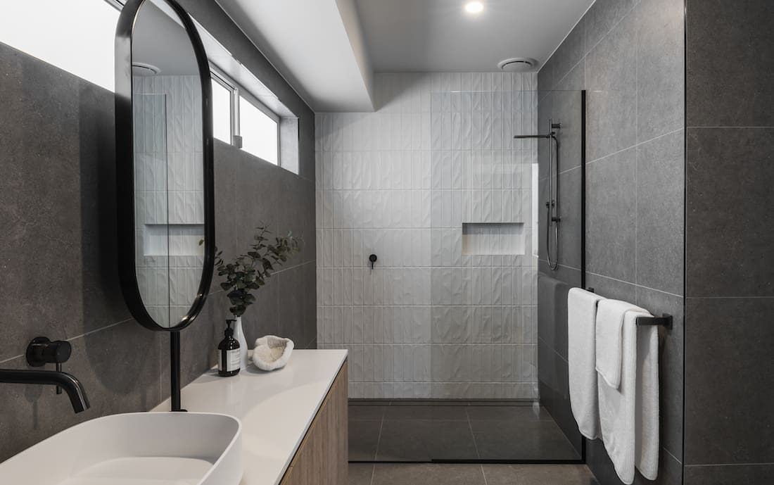 Grey bathroom with textured white tiles