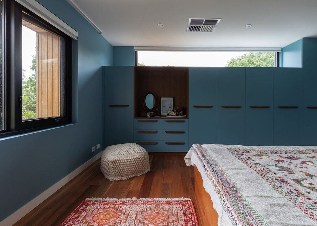 Bedroom with custom blue cabinetry