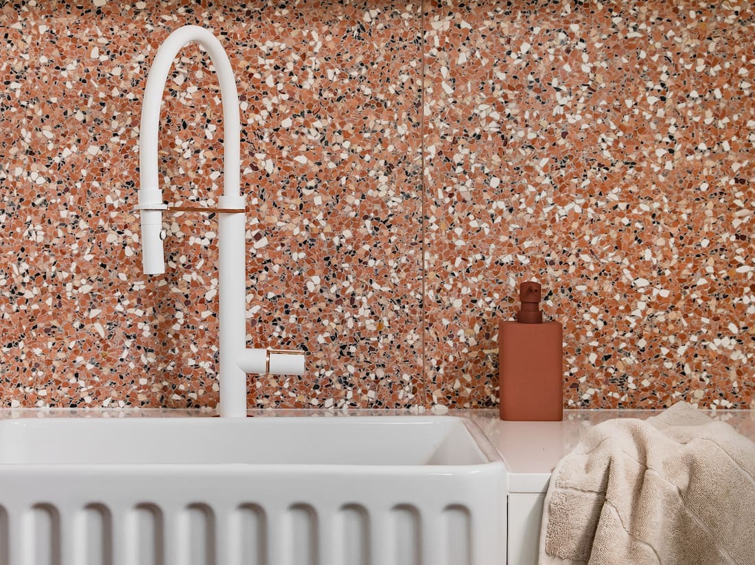 White scalloped farmhouse sink with Terrazzo bathroom with Fibonacci Stone Fatima's Reflection terrazzo