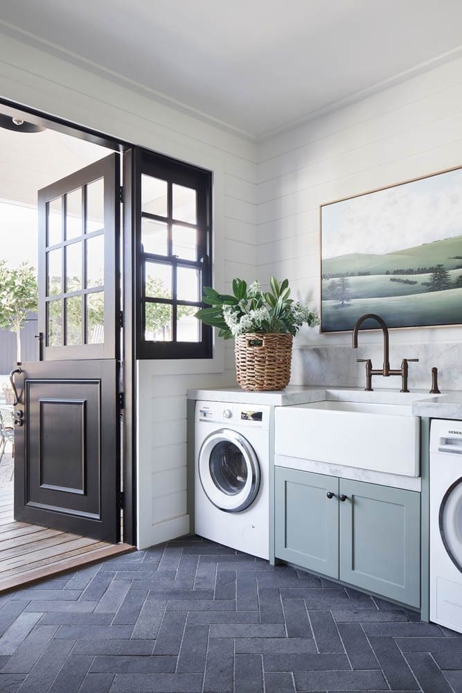 Modern country style laundry with green cabinetry