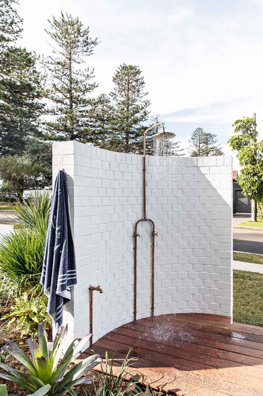 Aged outdoor shower with curved wall