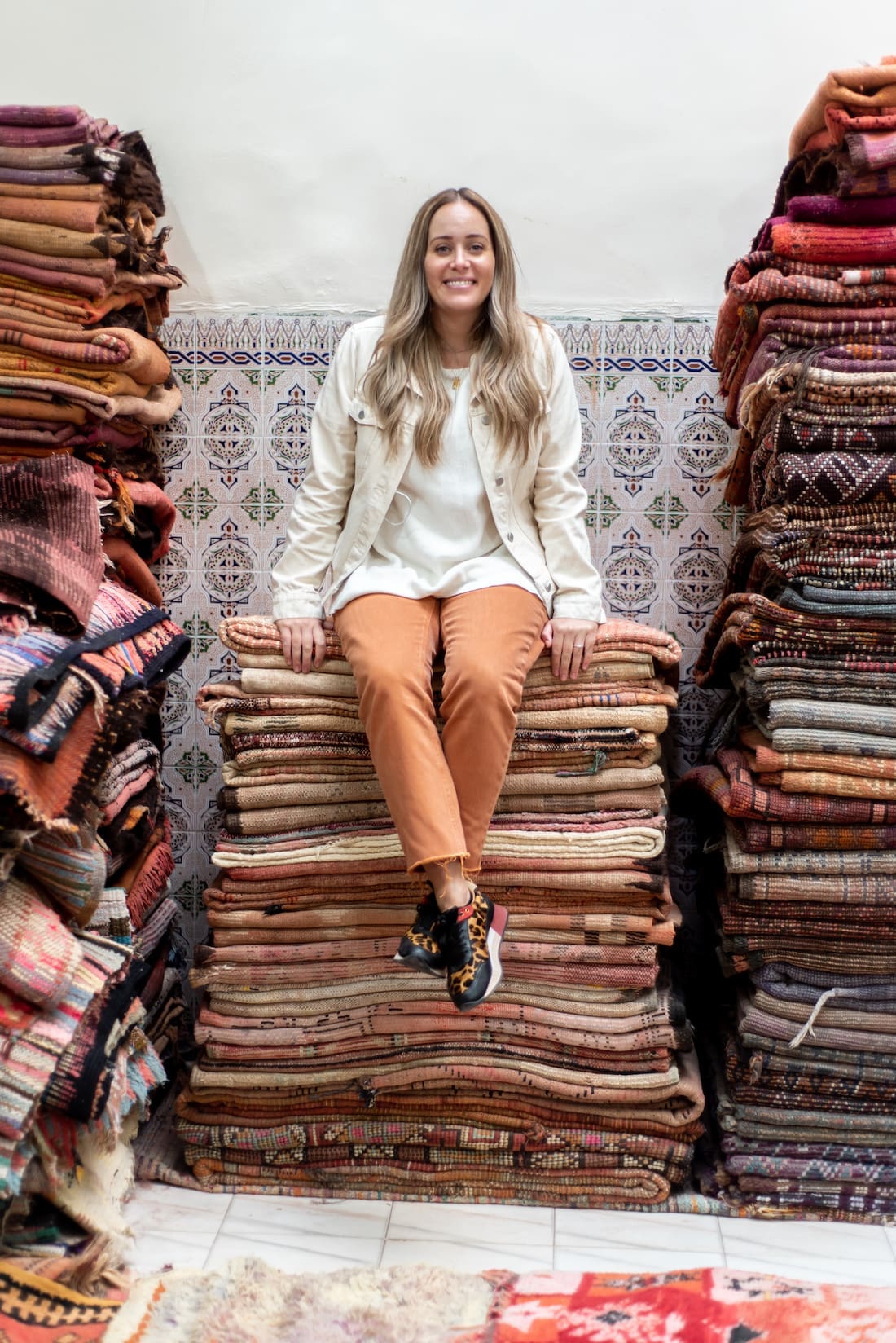 Stack of Moroccan textiles with Chantelle Traficante from Beni Kesh