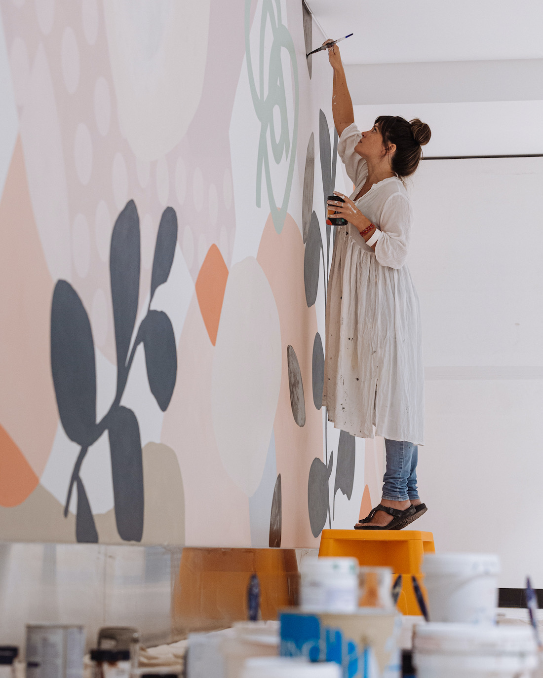 Kiasmin painting a mural