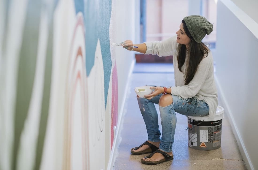 Painting a mural by artist Kiasmin