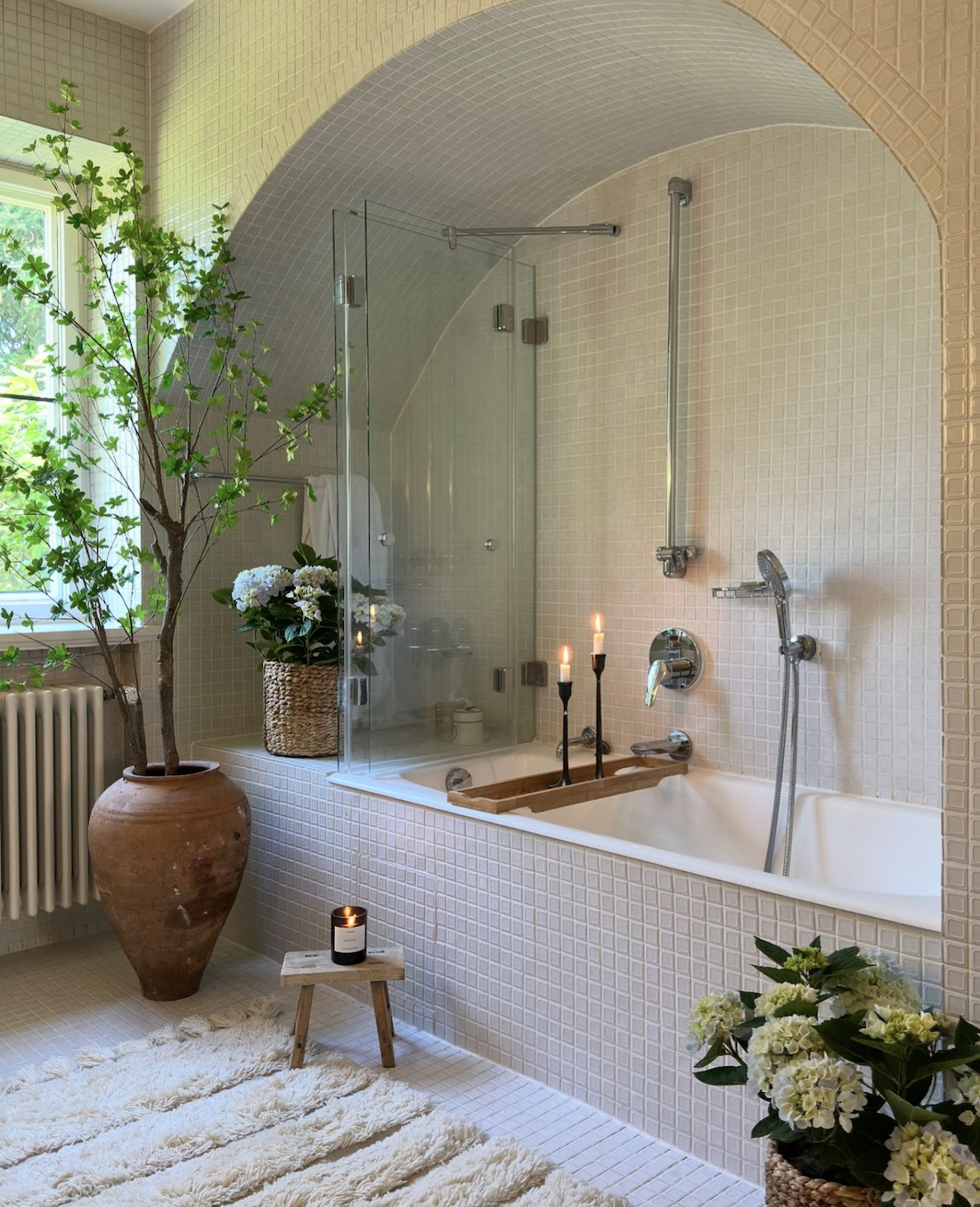 Arch shower and bath in earthy bathroom