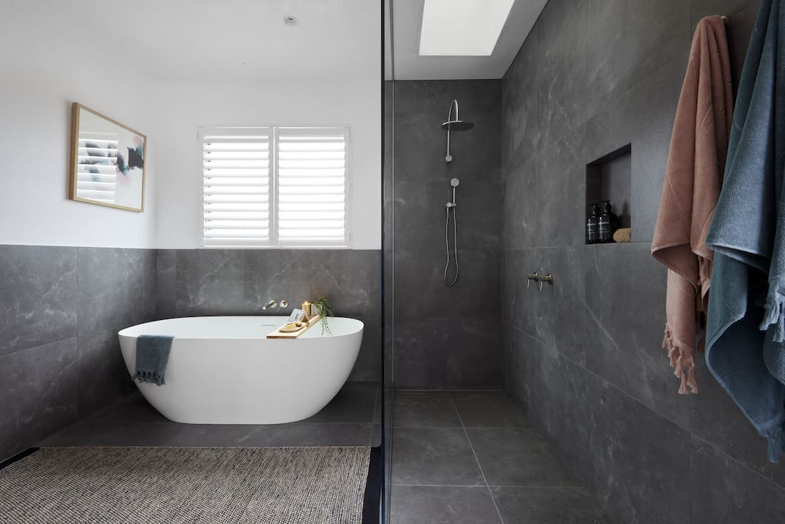 Dark bathroom with freestanding bath