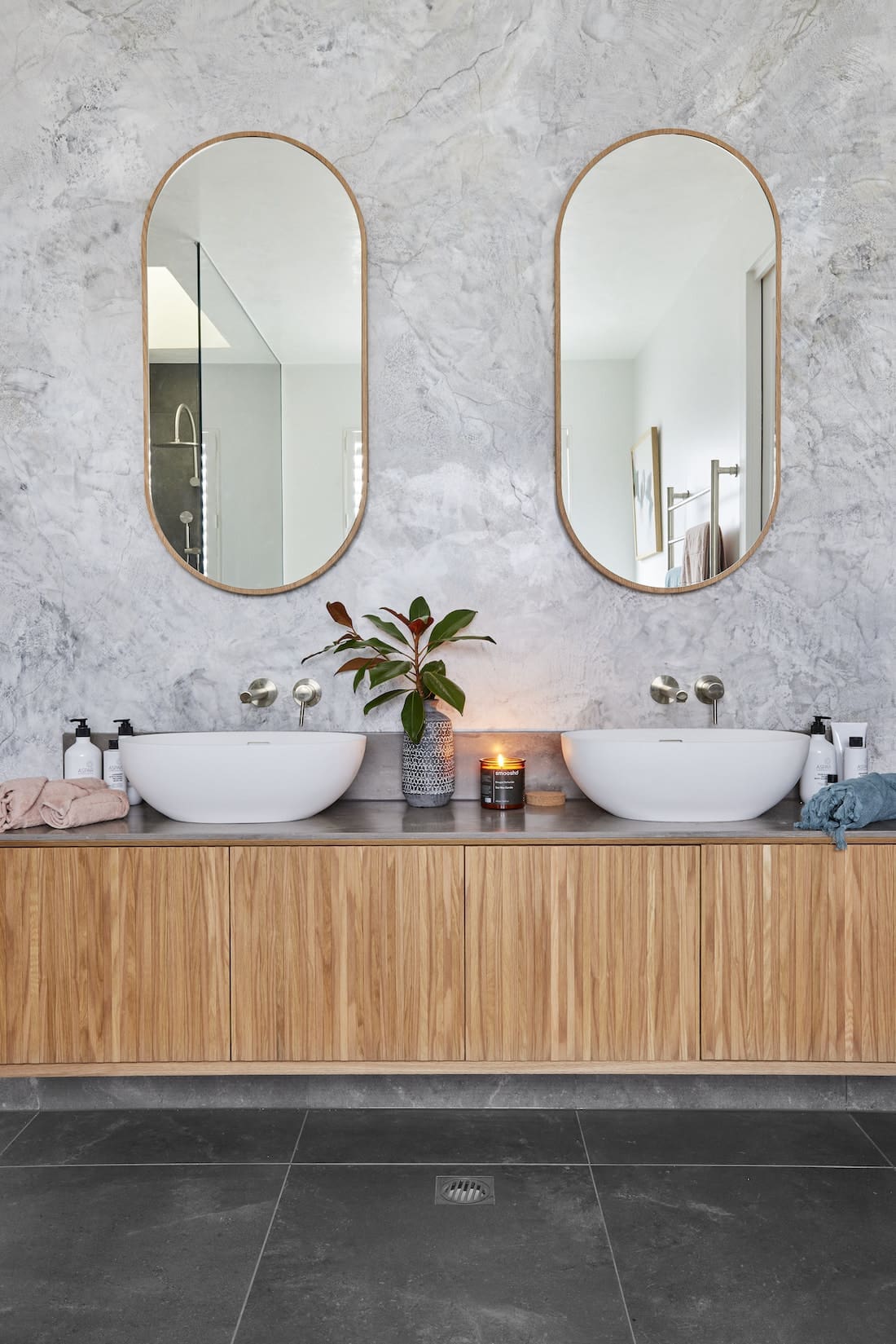 Timber vanity with pill shaped mirrors