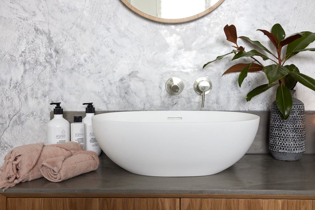 Curved basin with Venetian plaster wall