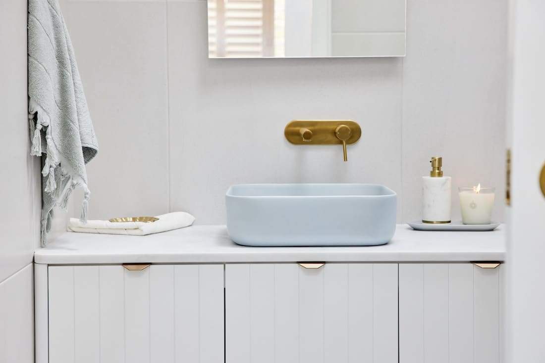 Blue rectangular sink in white bathroom