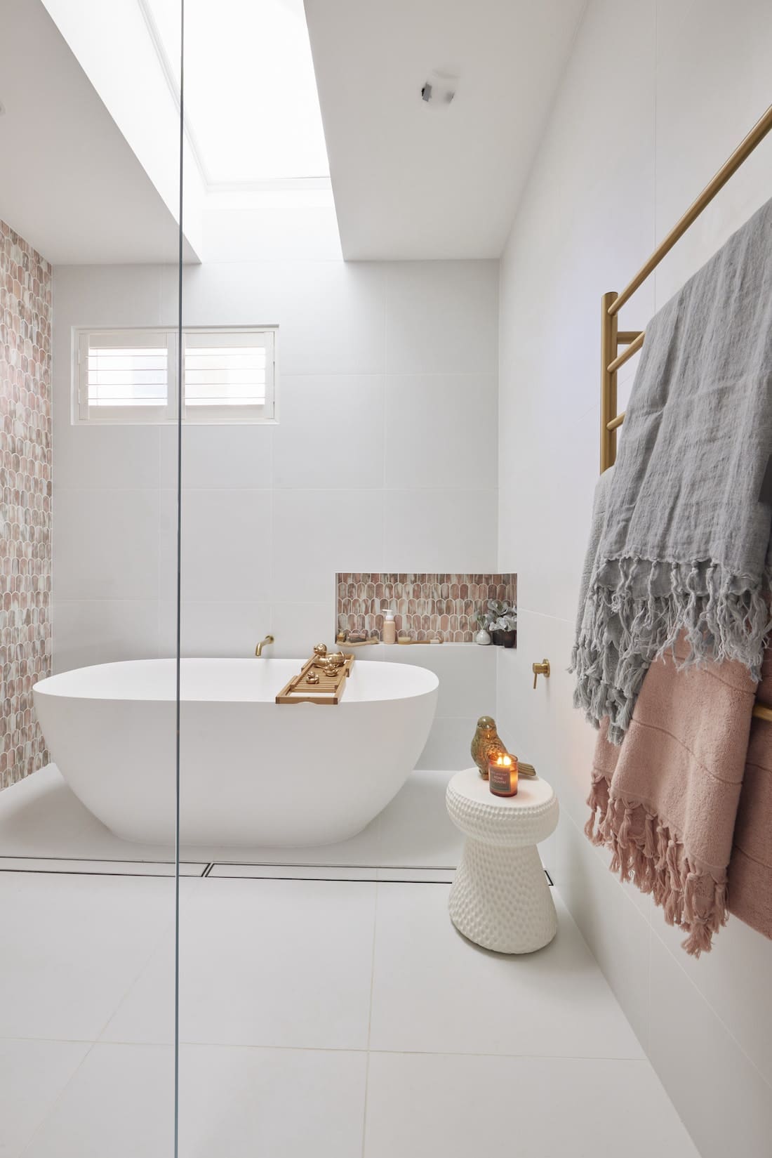 Freestanding matte white bath in pink bathroom