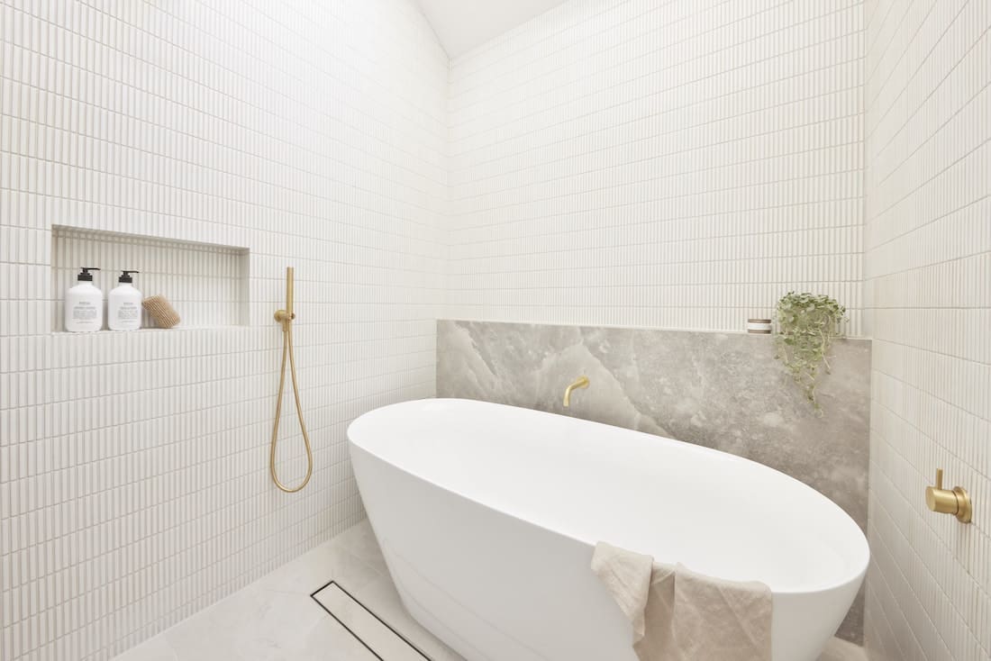 Guest bathroom with white kit kat tile and freestanding bath