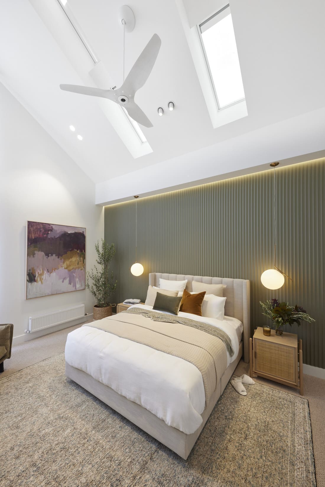 Sage green fluted feature wall with skylights in cathedral ceiling