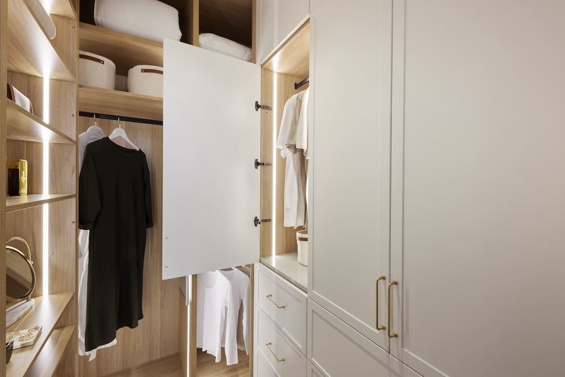 Walk in wardrobe in master bedroom showing storage