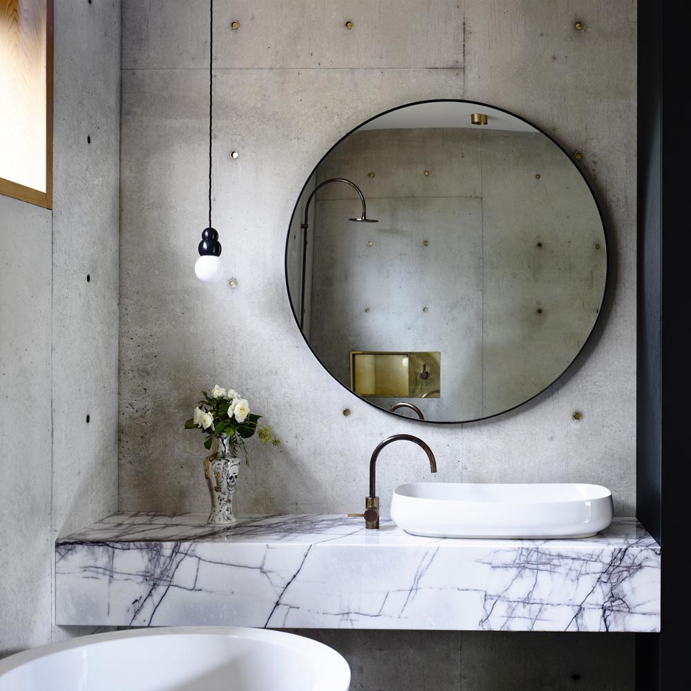 Concrete wall with round mirror