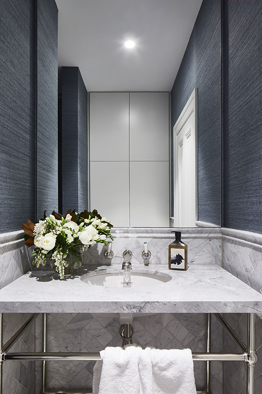 Frameless mirror in bathroom with marble features