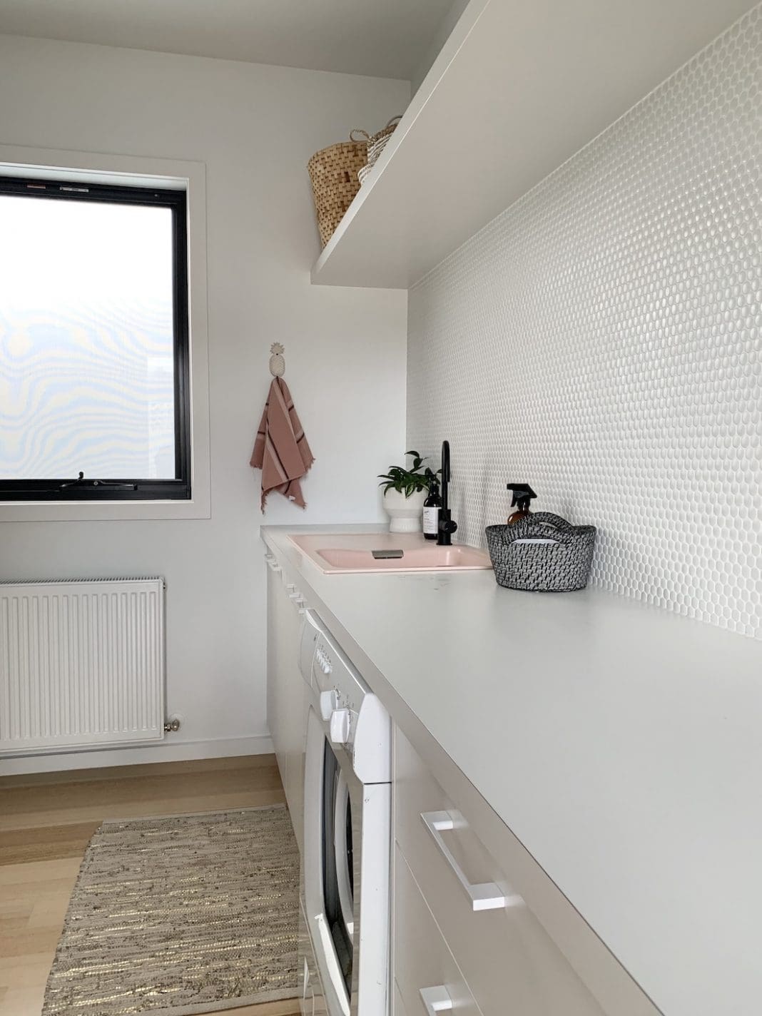 Chic laundry: White penny tiles, black tapware and a nude pink sink ...