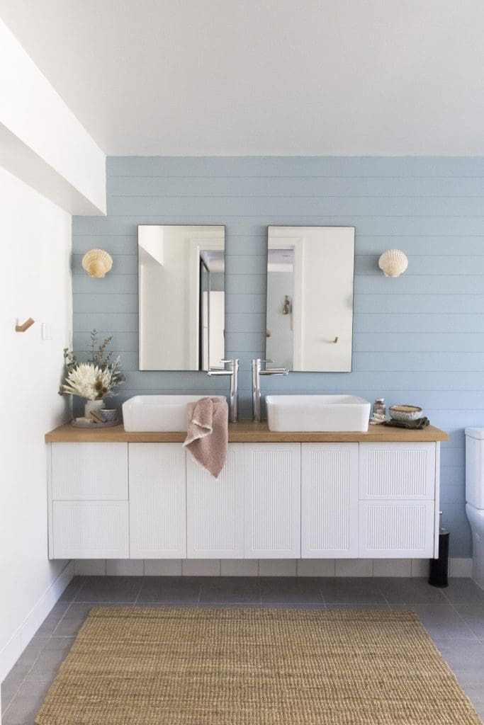 A relaxed, beachy bathroom with powder blue feature wall