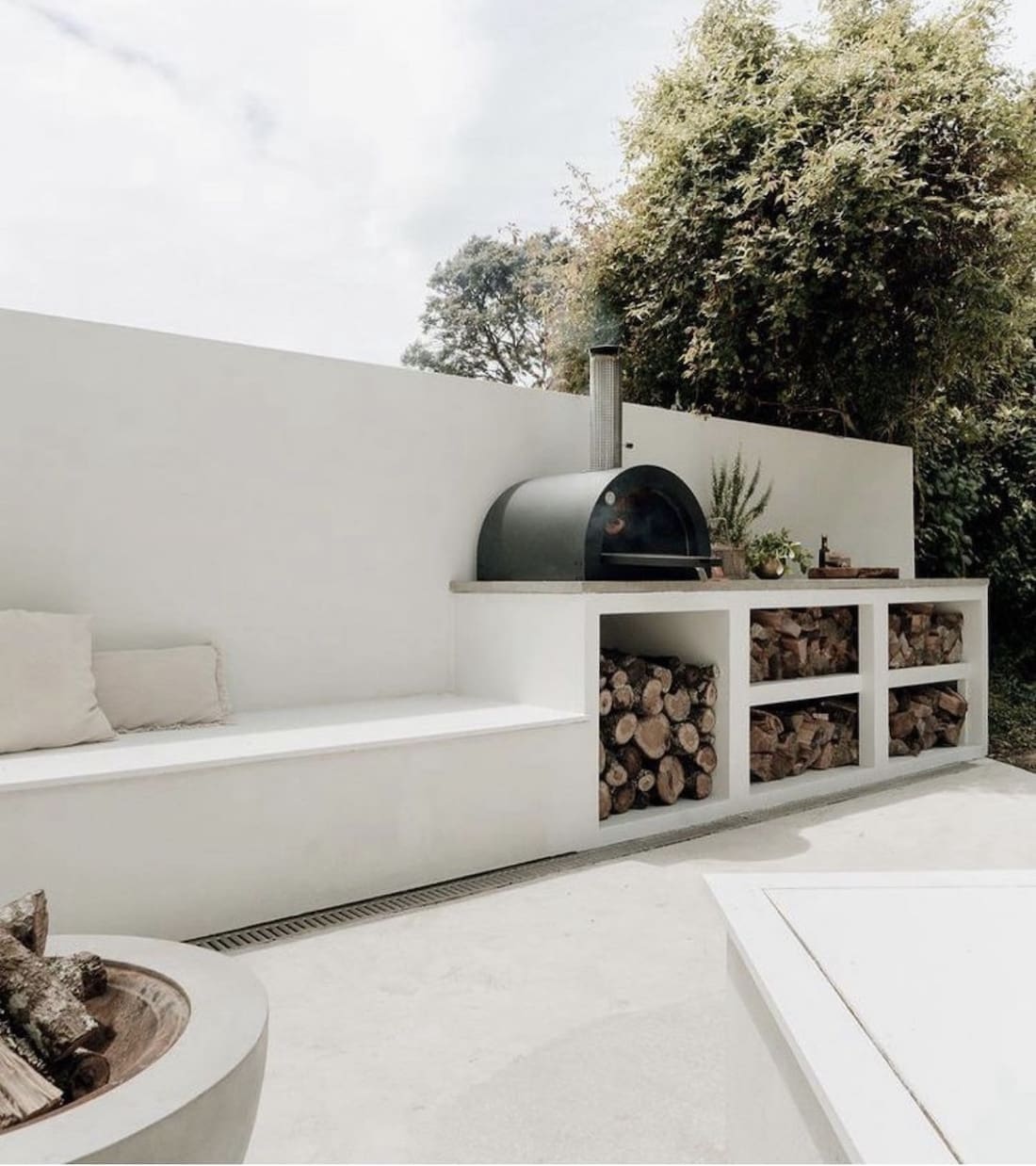 White concrete bench and pizza oven