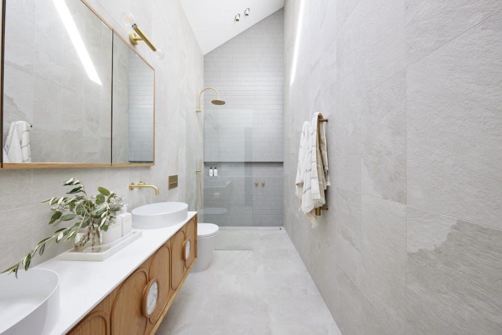 Grey and timber ensuite with gold accents
