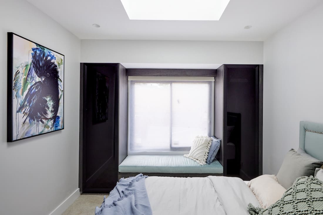 Window seat with dark timber wardrobes