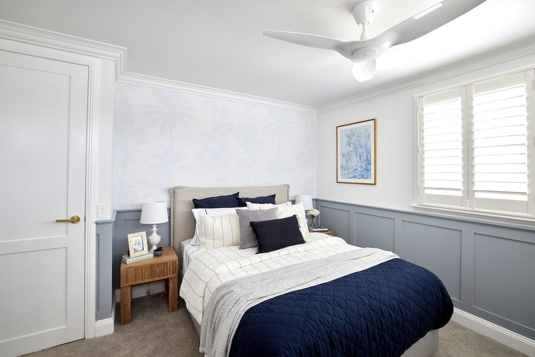 Guest bedroom with blue wainscoting