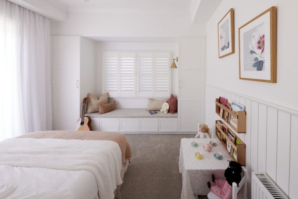 Girls bedroom with built in window seat